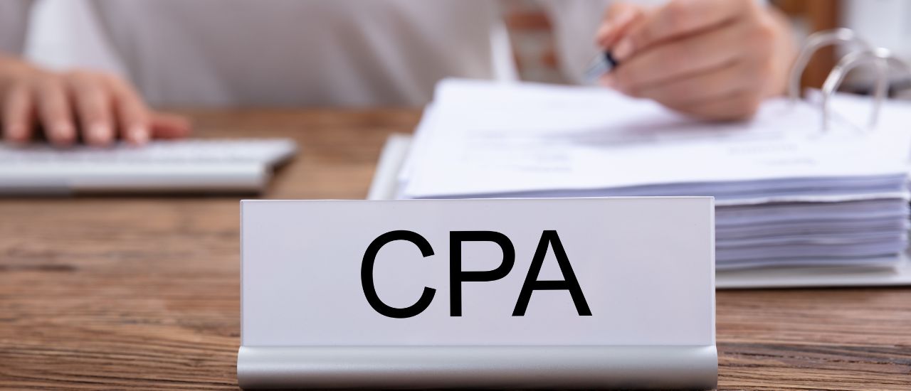 photo of a desk with a cpa sign to represent corporate tax planning